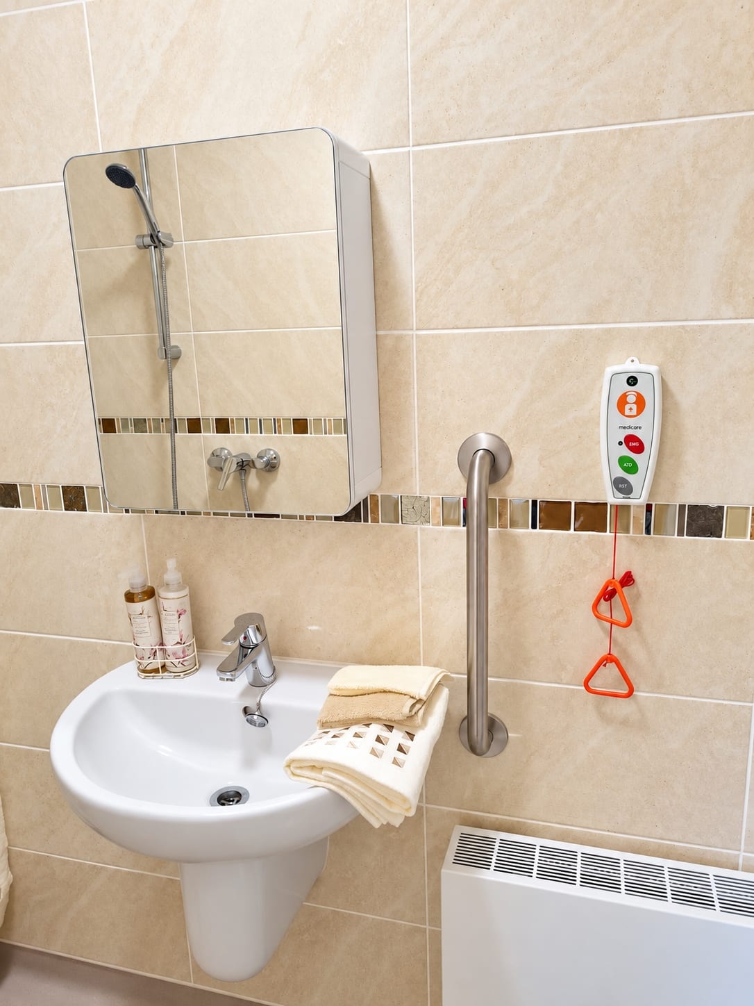 Grab rail and a personal alarm call unit with a pull-cord beside the basin.